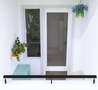 A balcony in a 3-room apartment in Bratislava - Petržalka with plants and hanging decorations.