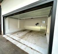 Open garage on Mäsiarska Street in Košice, Old Town, with white walls.