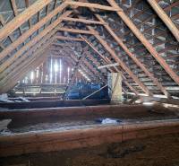 Attic space of the cottage with wooden beams and roof structure.
