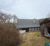 A cottage on Zánemecká Street in Hriňová, surrounded by trees and a garden.
