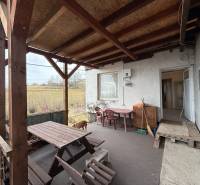 Terrace of the cottage on Zánemecká Street in Hriňová with a wooden shelter and outdoor furniture.