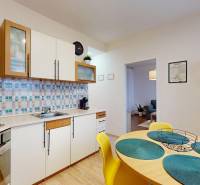 A kitchen in a 3-room apartment with colorful tiles and wooden decor.