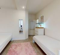 Children's room with two beds and a wooden decor floor in a three-room apartment.