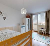 Children's room in a 3-room apartment with balloon decor and wooden decor flooring.