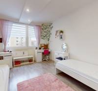 Children's room in a 3-room apartment with a wood-patterned floor, two beds, and a desk.