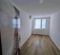 A narrow room with a wooden decor floor and a window in a 5 or more room apartment.