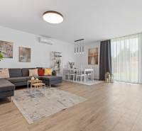 Living room in a 3-room apartment with a comfortable sofa and a wooden decor floor.