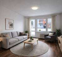 Living room in a two-room apartment with wood-patterned flooring and light furniture.
