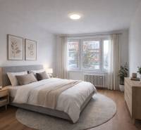 Bright bedroom in a two-room apartment with a window, bed, and wooden decor flooring.