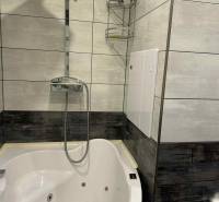 A bathroom with a modern shower and bathtub in a 3-room apartment.