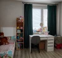 Children's room with a bed, desk, and shelf, 3-room apartment, floor with wooden decor.