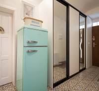 Entrance hallway with a vintage refrigerator in a studio apartment with decorative tiles.