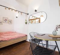 Stylish interior of a one-bedroom apartment with wood-patterned flooring and comfortable furniture.