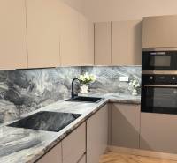 A kitchen in a 4-room apartment with a marble countertop and built-in appliances.