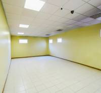 A bright room with pale walls and tiles in the production area.