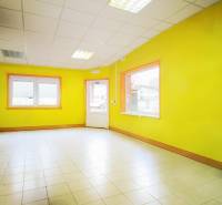 Production premises with bright yellow walls and white tiles.