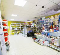 Interior of a workshop with shelves full of building materials and tools.