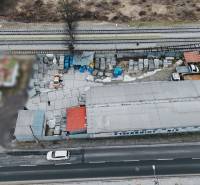 The production premises in Konská, next to the railway track, contain materials and vehicles.