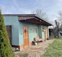 A family house on Hodská Street in Galanta with a lawn and a wooden bench.