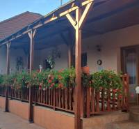 A family house on Hodská Street in Galanta with a wooden terrace and floral decorations.