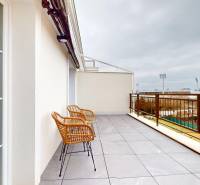 The balcony of a 1-room apartment in Komárno with a view of the city sports facilities.