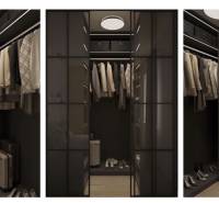 A wardrobe in a 3-room apartment with glass doors and a shelving system, flooring with a wood decor.