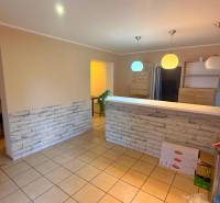 A kitchen counter in a gastro space with lights and brick cladding.