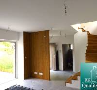 Interior of a 3-room apartment with a staircase and flooring with a wooden decor.