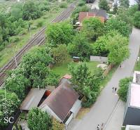 Aerial view of the Sunny Lakes South in Senec, with a railway track and greenery.