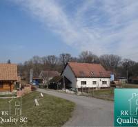 A rural road with houses and trees at the Old Port Gabčíkovo, plots - housing.