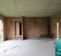 The interior of a family house, unplastered brick walls, view into an incomplete room.