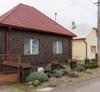 A family house in Bobot on Bobot Street, with a red-tiled roof and a landscaped garden.
