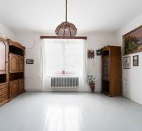 Interior of a family house with furniture, white walls, and a floor with a wooden decor.