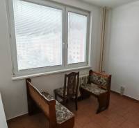 Interior of a 3-room apartment with furniture, wood-patterned flooring, and a large window.