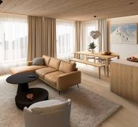 Interior of a 4-room apartment with a wooden decor floor, comfortable sofa, and dining table.