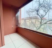 A glazed balcony with ceramic tiles offers a view of Košická Street in Bratislava.