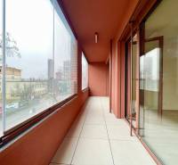 A glazed balcony with a view of the school and the city street in Bratislava on Košická.