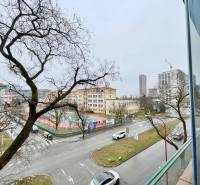 View of Košická Street in Bratislava with trees and urban architecture.