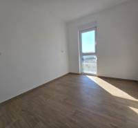 A room in a family house with white walls and a floor with a wooden decor.