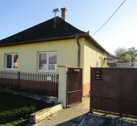 A family house on Mechenice Street in the town of Podhorany, with a front yard and a gate.