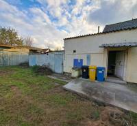 A family house on Mechenická Street in Podhorany with a yard and containers for sorted waste.