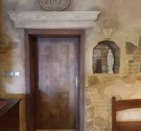 Doors with a stone decor and a niche with a statue, commercial premises.