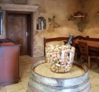 Interior of commercial premises with a wooden barrel, furniture, and a wall with decorative elements.