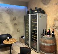 Interior commercial spaces with wine refrigerators, a barrel, and a map wall.