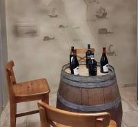 Interior scene with a wine-colored table made from a wooden barrel and a drawn map on the wall.