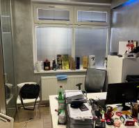 Office with a window, desk, and various office supplies in commercial premises.