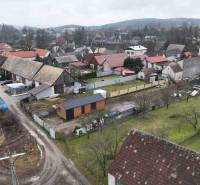Rural scenery and gardens in Kláštor pod Znievom, with visible rooftops of houses and trees.