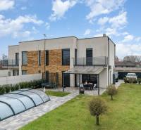 A family house in Dunajský Klátov with a terrace, swimming pool, and well-maintained garden.