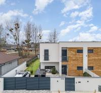 A family house in Dunajský Klátov with a modern facade and a landscaped garden.