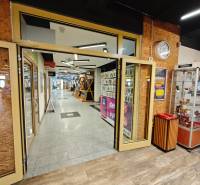 Interior with wood-decor flooring, display case, and hallway in gastronomic premises.